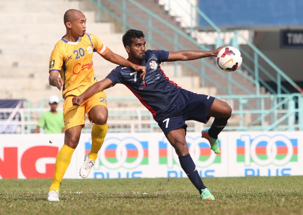 Hattrick hero Ashfaq Ali (right) attempts a left foot volley while under pressure. Picture by KAMARUL AKHIR/asiana.my