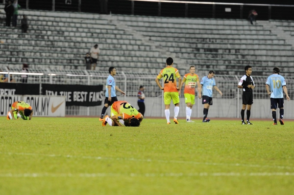 Some of PKNS' players, including Ally Imran (second from right) kiss the ground in delight after beating Forces in the league. Picture by MOHD ADIB HAKIMsports247.my
