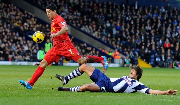 Suarez (left) breaks free from countryman Diego Lugano at the Hawthorns. AFPpic