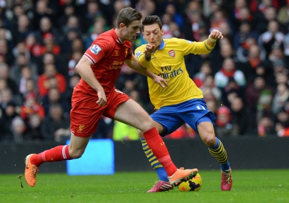 Arsenal (yellow) will be desperate to turn the tables on Liverpool after their 5-1 mauling last weekend/AFP pic.